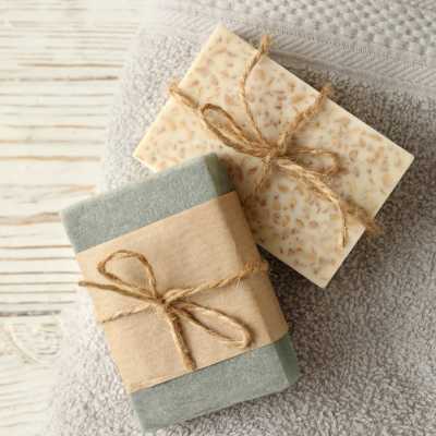 Collection of goat milk soaps, lotions, natural beeswax lip balms, and other bath essentials.